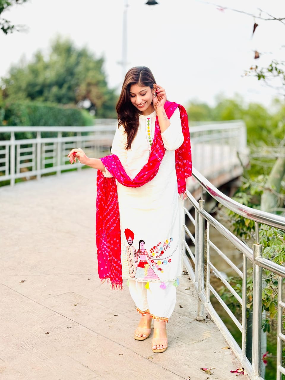 Woman In Traditional Indian Attire Or Embroidered Kurta Set With pink Bandhej Dupatta Set
