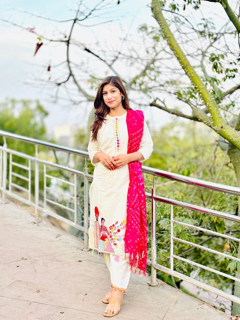 Woman In Traditional Indian Attire Or Embroidered Kurta Set With pink Bandhej Dupatta Set